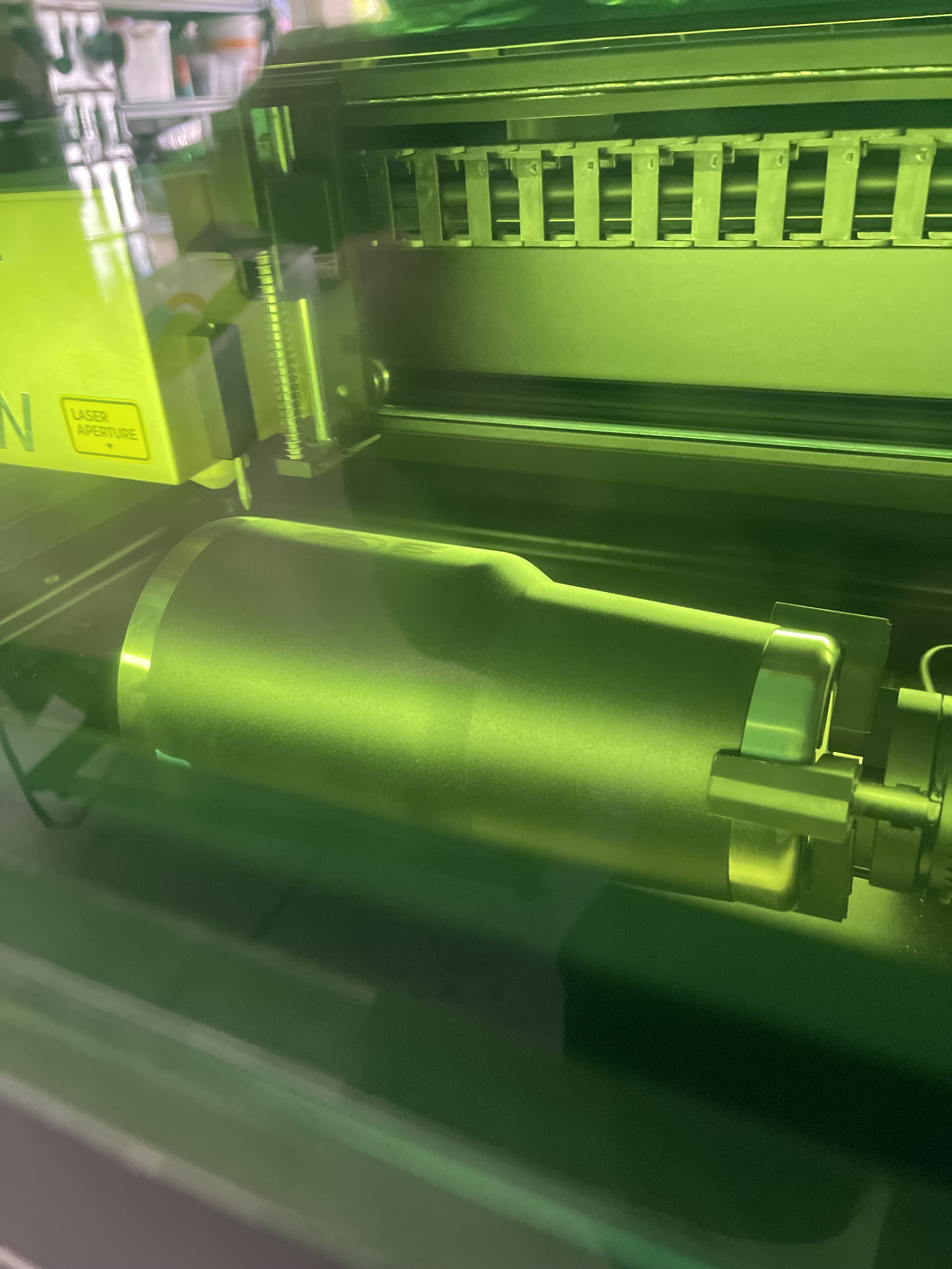 Craftsman working with laser engraving equipment in workshop